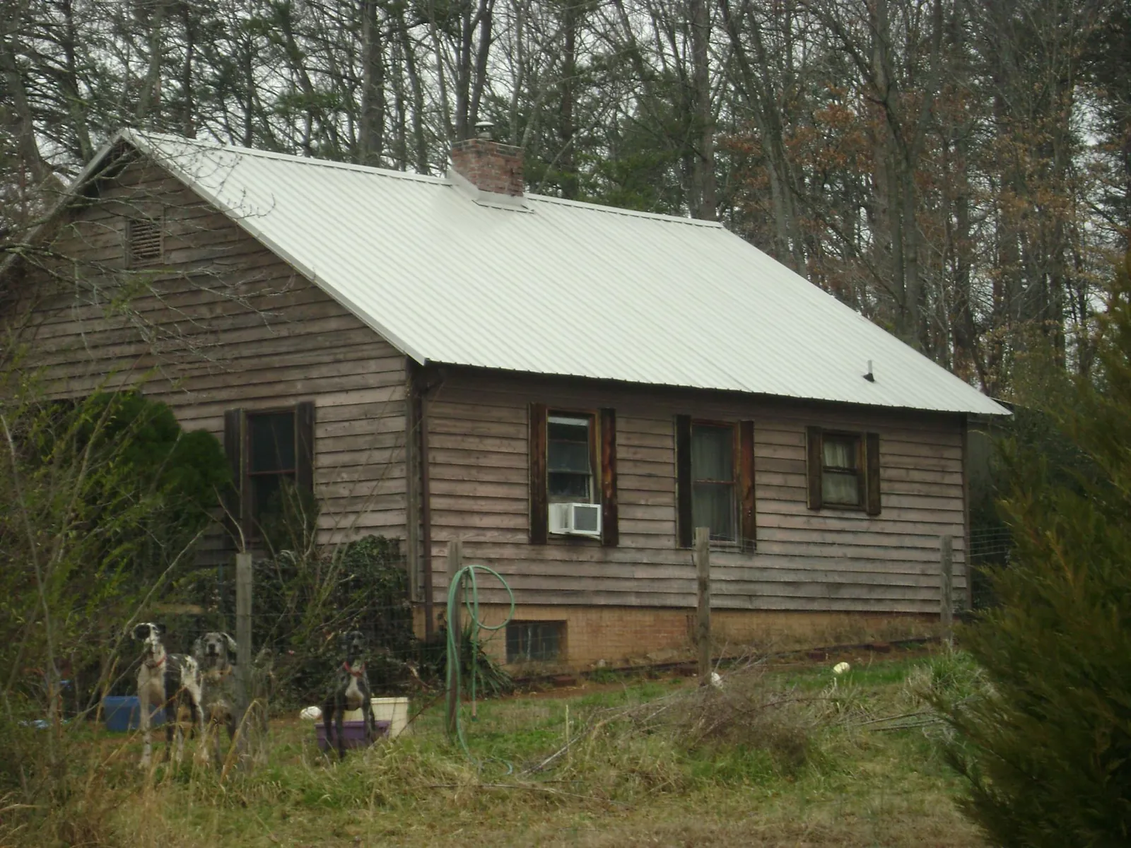 White metal roof on an old wood sided farmhouse, from a Metal Roof Installation job in Thornville